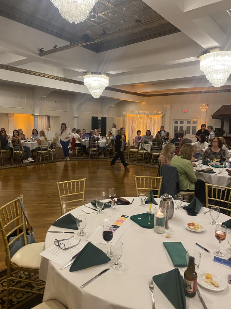 Women golfers hosting a party in the clubhouse. 2 women are seen occupying the dance floor.